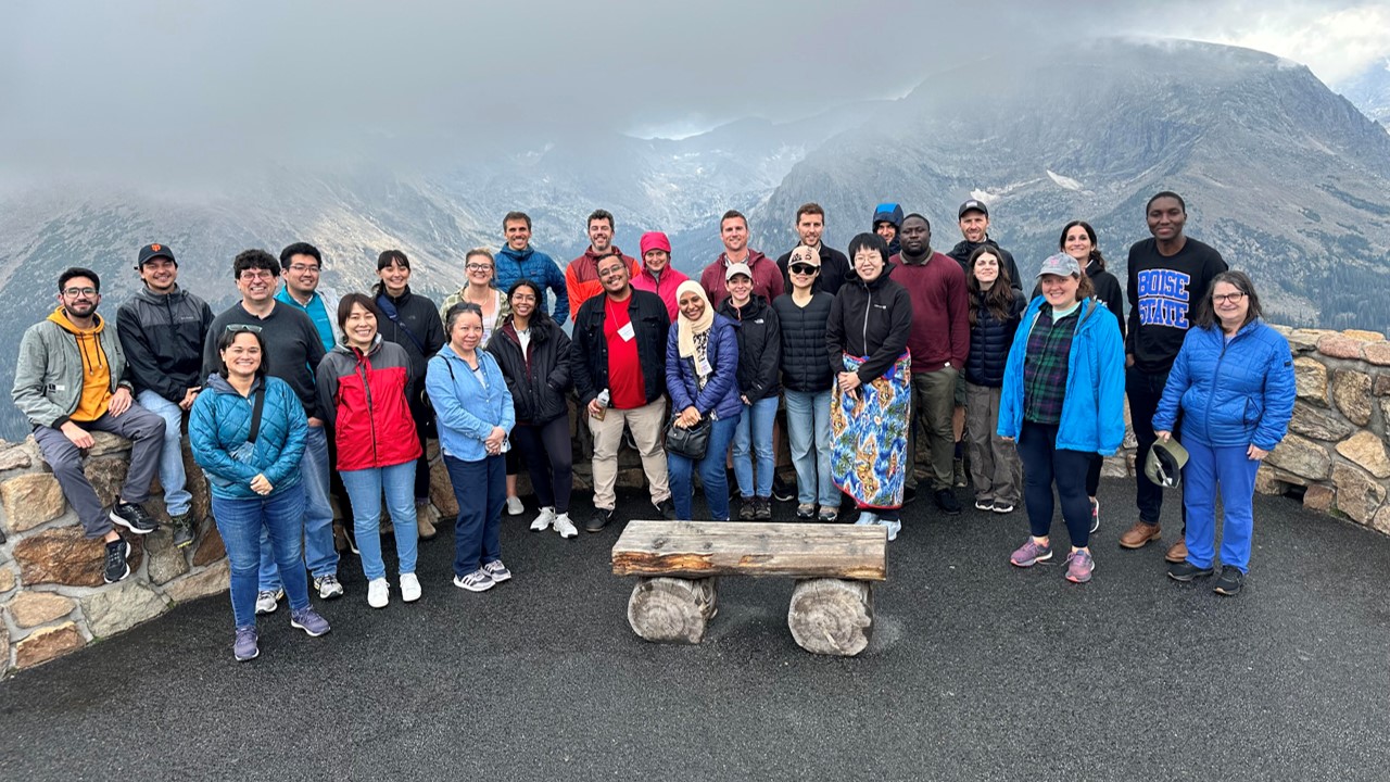 People standing together in front of mountains in the fog